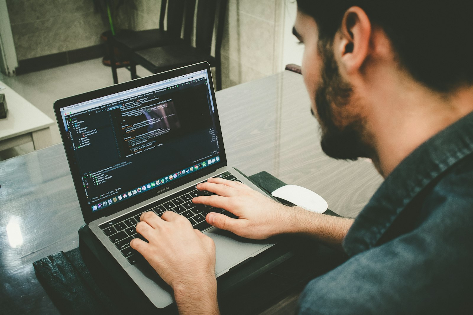A developer programming on a laptop